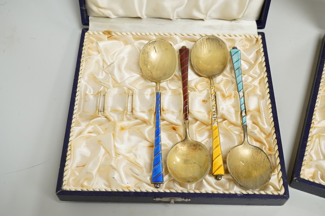 An Edwardian silver elliptical shaped inkstand, with two mounted glass wells and central pen wipe, James Dixon & Sons, Sheffield, 1906, together with ten Danish sterling and polychrome enamel spoons(a.f) and a cased set